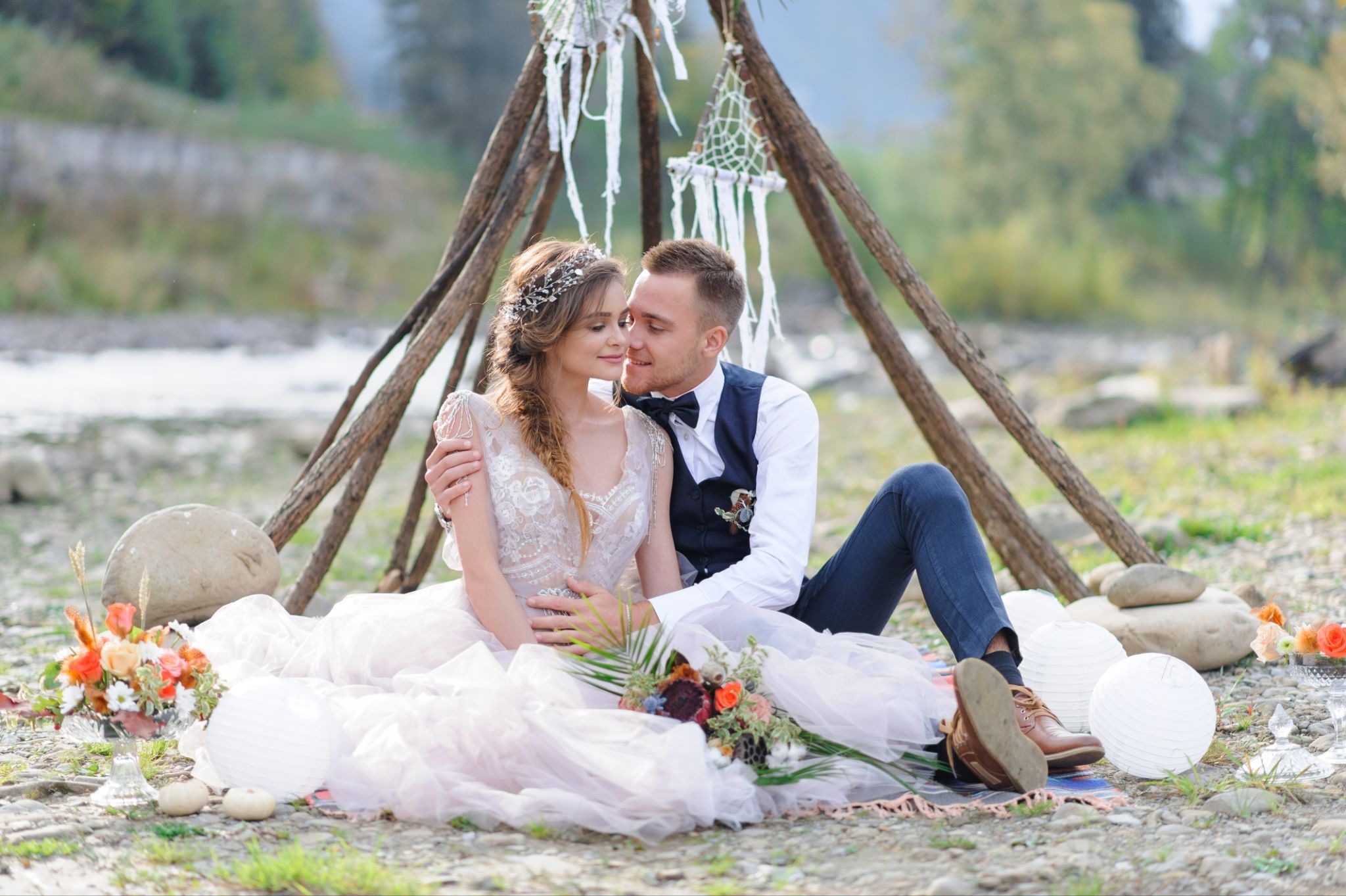 A couple in Boho Wedding Dresses and Attire